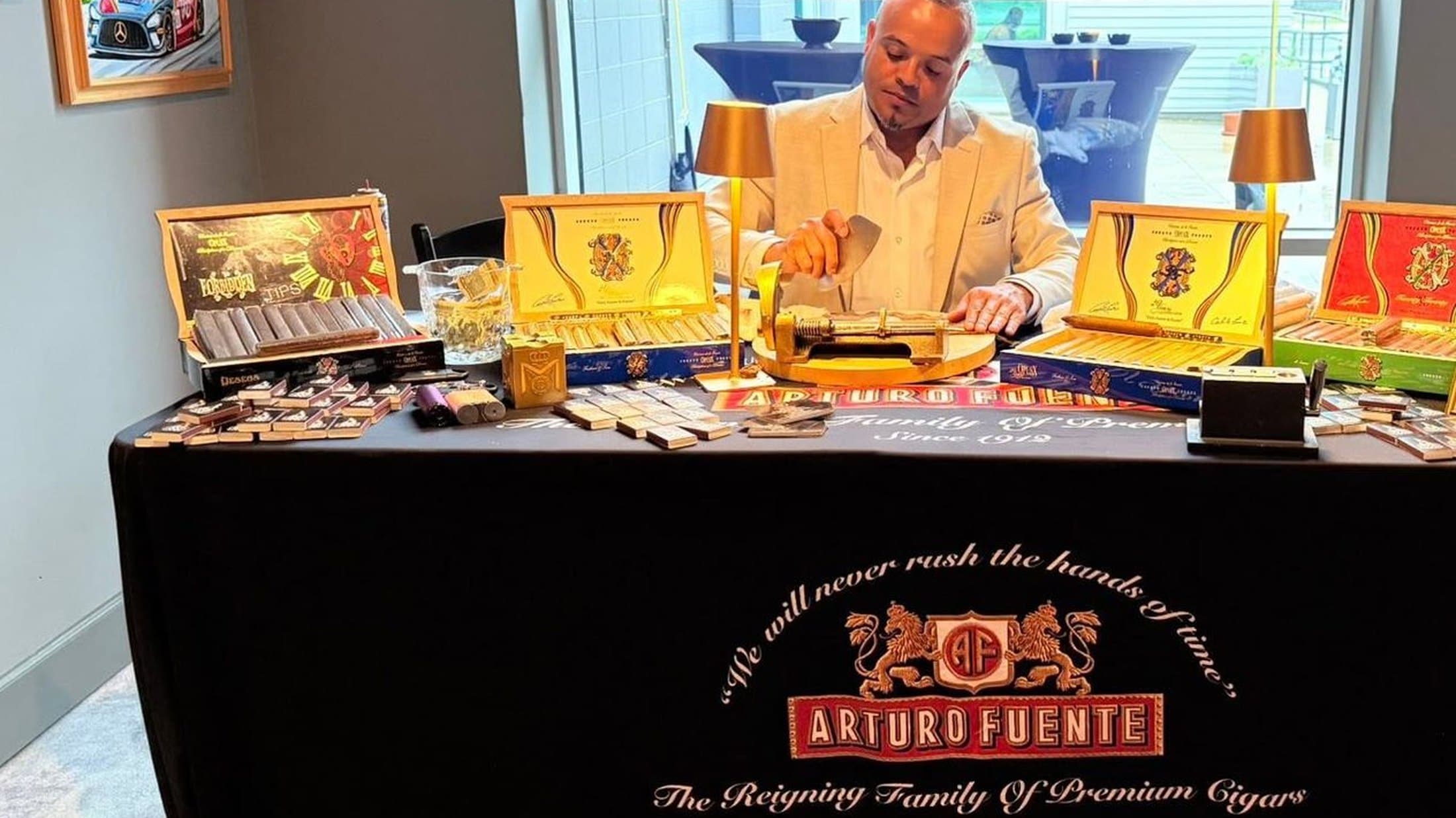 Franklin rolling at his table under the Arturo Fuente cloth