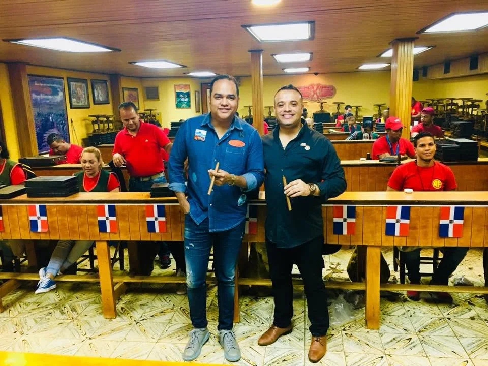 Franklin Pichardo standing between the rolling benches of the Arturo Fuente factory in Santiago