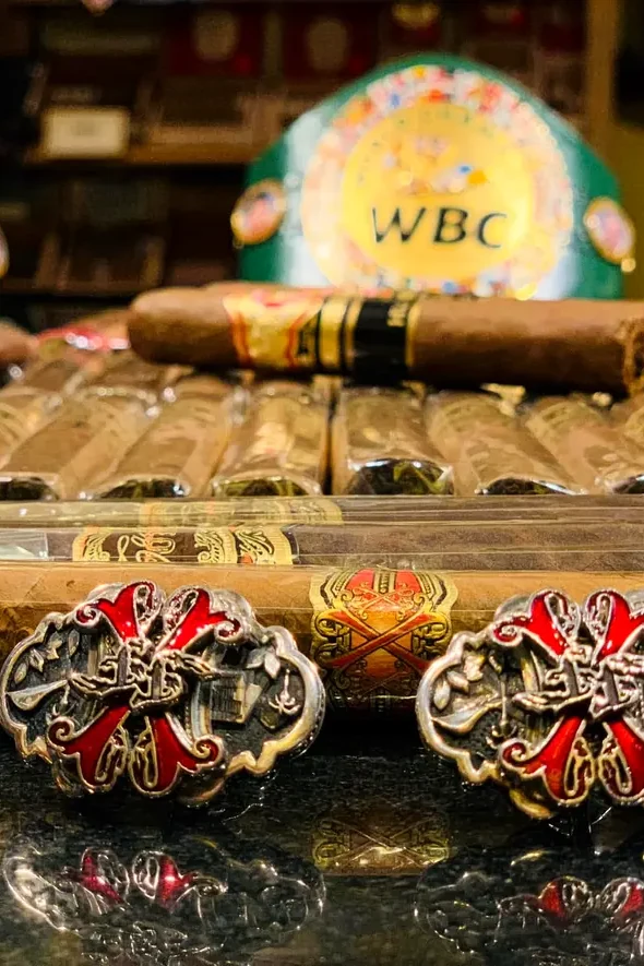 His cigars in front of the World Boxing Council belts
