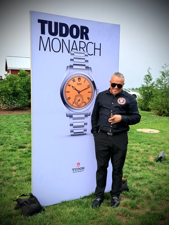 Franklin Pichardo beside a Tudor Monarch display at an evening event